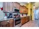 Stylish kitchen features stainless steel appliances, granite countertops, and dark wood cabinets at 9338 Clearmeadow Ln, New Port Richey, FL 34655