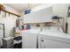 Laundry room with washer, dryer, and storage cabinets at 9338 Clearmeadow Ln, New Port Richey, FL 34655