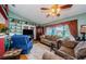 Spacious living room featuring comfortable seating and large windows at 9338 Clearmeadow Ln, New Port Richey, FL 34655