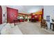 Open concept living area with a red accent wall and comfortable seating at 9338 Clearmeadow Ln, New Port Richey, FL 34655