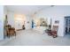 Spacious living room with a beige couch and rocking chair at 9338 Clearmeadow Ln, New Port Richey, FL 34655