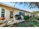 Private patio with grill and seating area, overlooking backyard at 9338 Clearmeadow Ln, New Port Richey, FL 34655