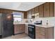 View of kitchen with wood cabinets and appliances at 9744 Rainelle Ln, Port Richey, FL 34668