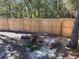 Backyard with wooden fence, landscaping, and rustic decor at 11743 Purdue St, New Port Richey, FL 34654