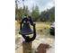 Large backyard with a bell, a wooden fence, and a partial view of a vehicle at 11743 Purdue St, New Port Richey, FL 34654