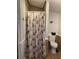 Bathroom with seashell shower curtain and tiled floor at 11743 Purdue St, New Port Richey, FL 34654