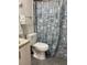Bathroom with blue seashell shower curtain at 11743 Purdue St, New Port Richey, FL 34654