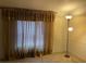 Bedroom with gold curtains and carpeted floor at 11743 Purdue St, New Port Richey, FL 34654