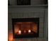 Lit fireplace with three candles creating a warm ambiance at 11743 Purdue St, New Port Richey, FL 34654