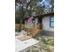 Steps leading to the front entrance of a manufactured home, featuring a wooden railing and a US flag at 11743 Purdue St, New Port Richey, FL 34654