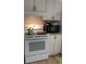 White kitchen appliances, including a stove, oven, and microwave at 11743 Purdue St, New Port Richey, FL 34654