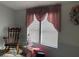 Living room with a rocking chair, small Christmas tree, and decorative window coverings at 11743 Purdue St, New Port Richey, FL 34654