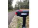 Black mailbox with the address number 11743 on a gravel road at 11743 Purdue St, New Port Richey, FL 34654