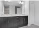 Elegant bathroom with double vanity and large mirror at 12040 Pine Warbler Ave, Brooksville, FL 34614