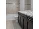 Bathroom with tub, vanity, and granite countertop at 12040 Pine Warbler Ave, Brooksville, FL 34614