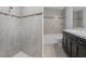 Bathroom with shower, bathtub, and dark brown vanity with granite countertop at 12040 Pine Warbler Ave, Brooksville, FL 34614