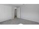 Bedroom with grey walls, carpet, and double door closet at 12040 Pine Warbler Ave, Brooksville, FL 34614