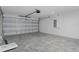 Unfinished garage with concrete floor and overhead door at 12040 Pine Warbler Ave, Brooksville, FL 34614