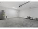Unfinished garage with concrete floor, door, and water heater at 12040 Pine Warbler Ave, Brooksville, FL 34614