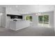 Modern kitchen with dark cabinets, granite countertops, and a breakfast bar at 12040 Pine Warbler Ave, Brooksville, FL 34614