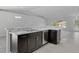 Eat-in kitchen with granite island and dark wood cabinets at 12040 Pine Warbler Ave, Brooksville, FL 34614
