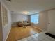 Light-filled living room with hardwood floors and neutral-toned furniture at 1207 Tamarac Dr, Holiday, FL 34690