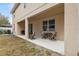 Covered patio with seating area, grill, and fenced backyard at 12307 Duckett Ct, Spring Hill, FL 34610