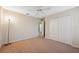 Well-lit bedroom with neutral walls, carpet, and a double door closet at 12307 Duckett Ct, Spring Hill, FL 34610