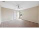 Simple bedroom with carpeted floor, ceiling fan, and window at 12307 Duckett Ct, Spring Hill, FL 34610