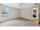 Cozy bedroom with a window, carpet, and access to another room at 12307 Duckett Ct, Spring Hill, FL 34610