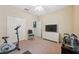 Bedroom with TV, exercise equipment, and double doors at 12307 Duckett Ct, Spring Hill, FL 34610