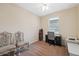 Bright bedroom with two chairs and a workspace at 12307 Duckett Ct, Spring Hill, FL 34610
