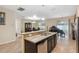 Open kitchen with island, granite counters, and view of dining area at 12307 Duckett Ct, Spring Hill, FL 34610