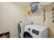 Laundry room with washer, dryer, and shelving for storage at 12307 Duckett Ct, Spring Hill, FL 34610