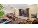 Living area with brown leather couches and a large entertainment center at 12307 Duckett Ct, Spring Hill, FL 34610