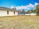 Large backyard with a screened-in pool and open space at 12312 Millington Ave, Weeki Wachee, FL 34614