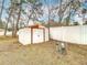 White metal storage shed in backyard with double doors at 12312 Millington Ave, Weeki Wachee, FL 34614