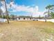 Spacious backyard with a view of the house and surrounding area at 12312 Millington Ave, Weeki Wachee, FL 34614