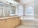 Bathroom with double vanity, soaking tub, and shower at 12312 Millington Ave, Weeki Wachee, FL 34614