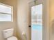 Bathroom with toilet and door leading to the pool area at 12312 Millington Ave, Weeki Wachee, FL 34614