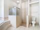 Bathroom features a walk-in shower, tile flooring, and a separate tub at 12312 Millington Ave, Weeki Wachee, FL 34614