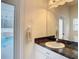 Bathroom with single sink, dark countertop and pool view at 12312 Millington Ave, Weeki Wachee, FL 34614