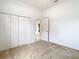 Bedroom with neutral walls, carpet, and double doors at 12312 Millington Ave, Weeki Wachee, FL 34614