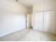 Empty bedroom with double door closet and access to hallway at 12312 Millington Ave, Weeki Wachee, FL 34614