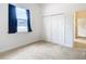 Bedroom with neutral walls, carpet, and double doors at 12312 Millington Ave, Weeki Wachee, FL 34614