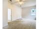 Primary bedroom with window and access to hallway at 12312 Millington Ave, Weeki Wachee, FL 34614