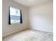 Bedroom with neutral walls, carpet, and window at 12312 Millington Ave, Weeki Wachee, FL 34614
