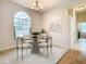 Charming dining room with a round glass table and modern chairs at 12312 Millington Ave, Weeki Wachee, FL 34614