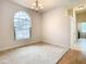 Dining room with carpet, chandelier, and large arched window at 12312 Millington Ave, Weeki Wachee, FL 34614