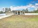 Tan house with attached garage and green door at 12312 Millington Ave, Weeki Wachee, FL 34614